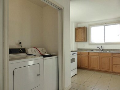 Kitchen. Main level laundry area includes washer &