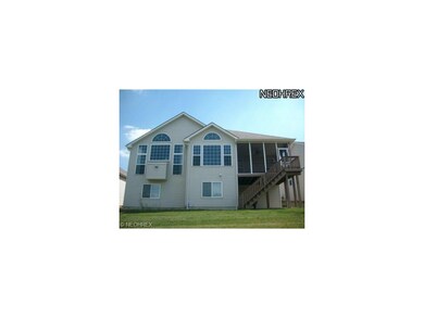 Rear view w/ walls of windows and screened porch w