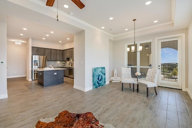 Sitting room with crown molding, ceiling fan with