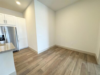 Kitchen with stainless steel fridge, light hardwoo
