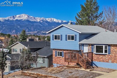 Tri-level home with brick siding, roof with shingl
