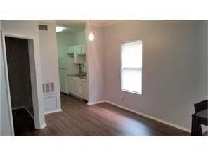 Unfurnished bedroom featuring dark wood-type flooring and baseboards
