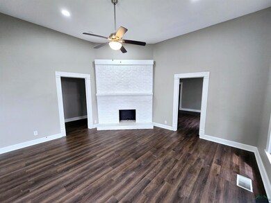 Unfurnished living room with dark wood-style floor