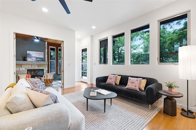 Living room featuring a ceiling fan, recessed lig
