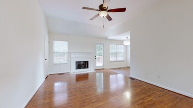 Bright, open living room with vaulted ceiling & tons of natural light.