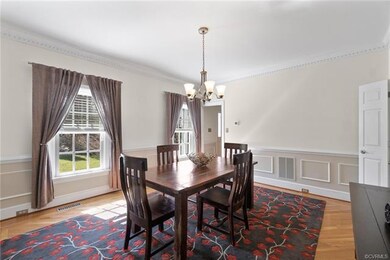 The formal dining room with hardwood floors, chair