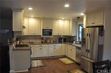 Kitchen features lovely white cabinets, stainless 