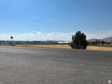 View of asphalt road featuring a mountain view and traffic signs