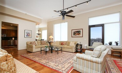 View from the entry looking towards the living area.  Notice the 12 foot high ceilings, crown molding and the wall of windows letting in plenty of natural light.