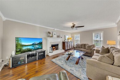Plenty of room to gather, with a beautiful fireplace and large windows to let the sunlight in.