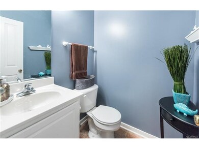 Larger powder room with white vanity for added sto