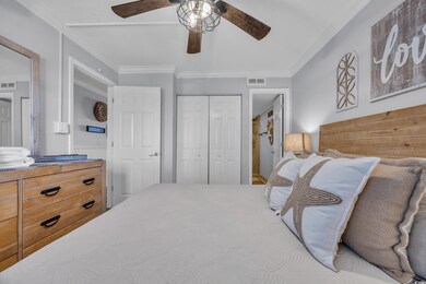 Bedroom with a closet, ornamental molding, and a ceiling fan
