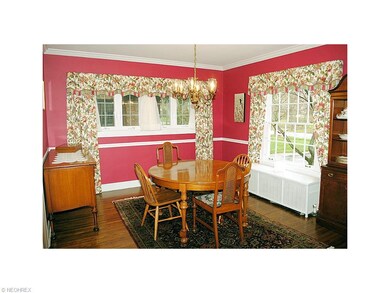 FORMAL DINING ROOM WITH WOOD FLOORING AND SWING DO