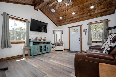 Living area with light wood-type flooring, wood ceiling, recessed lighting, and ceiling fan
