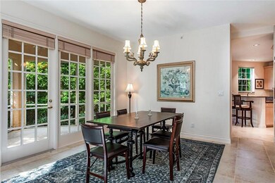 Tiled dining room featuring a notable chandelier