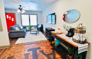 Living room featuring baseboards, wood finished fl