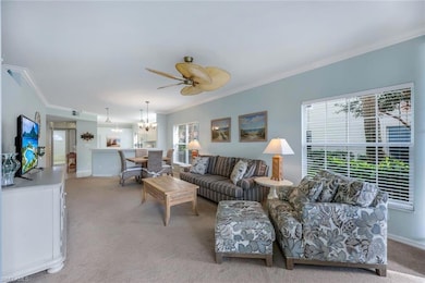 Carpeted living room featuring ornamental molding 