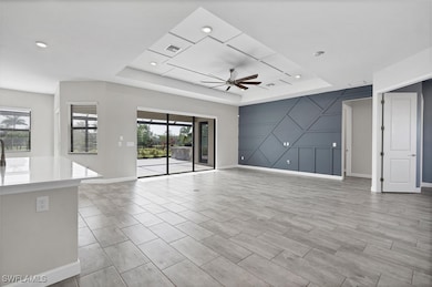 Unfurnished living room featuring a raised ceiling