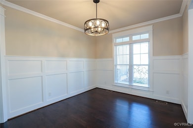 Dining room with dark hardwood / wood-style floori
