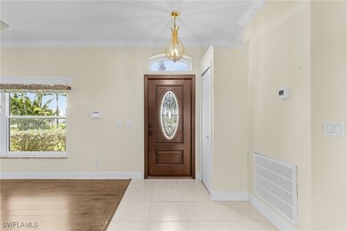 Foyer entrance with baseboards, ornamental molding