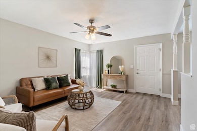 Living area featuring light wood-type flooring and a ceiling fan
