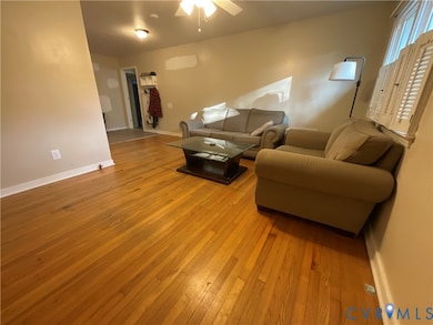 Living room featuring light wood-style floors and a ceiling fan