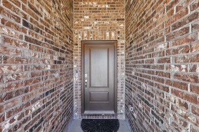 Property entrance with brick siding