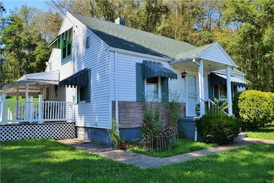 Cute cape cod with inviting covered side porch.