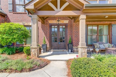 Property entrance with brick siding and french doo