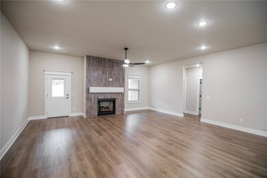 Wood-look ceramic tiled fireplace with modern mantle above the fireplace!