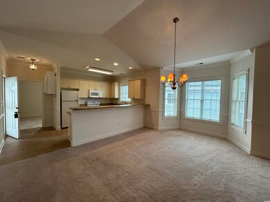 Kitchen with white cabinetry, white appliances, a 