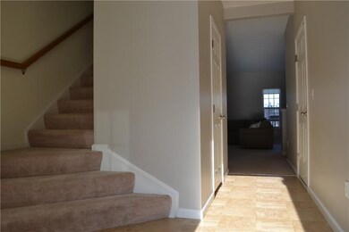 Bright entry with window and curved, wide staircas