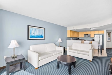 Living area featuring light carpet and baseboards