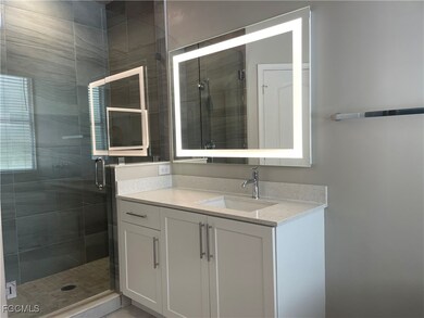 Bathroom with a stall shower and vanity