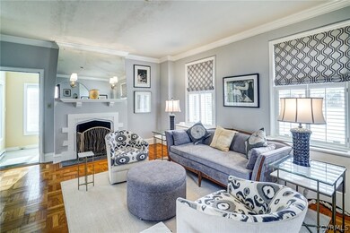 Living room has hardwood floors, 9'+ ceilings, pretty moldings and fireplace