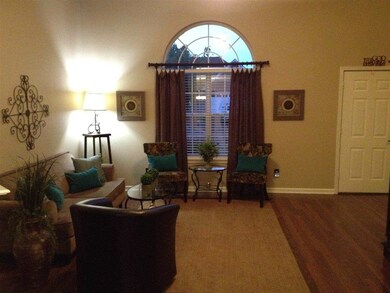 The living area has very high ceilings, large pict