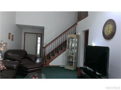 Living Room. Beautiful natural wood staircase lead