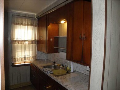 Kitchen. Sink area w/ Wood Cabinets off Eat-in Kit