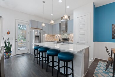 Kitchen featuring light countertops, dark wood-st