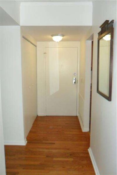 Entry hall with new hardwood floors and large coat