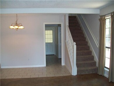 Tile in the dining area, kitchen, and both bathroo