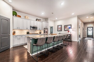 Spectacular kitchen features a huge island with br