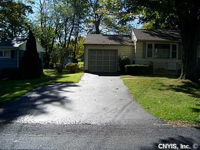 Garage Attached garage with blacktop driveway