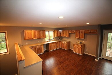 Brand new hickory cabinets, flooring and solid sur