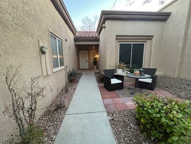 Entrance to property featuring a patio, a tile roo