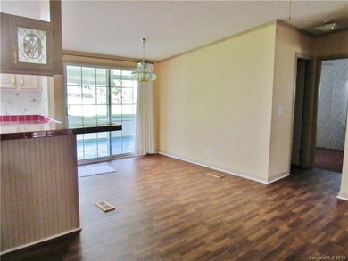 BREAKFAST BAR/ DINING AREA & ACCESS TO PATIO