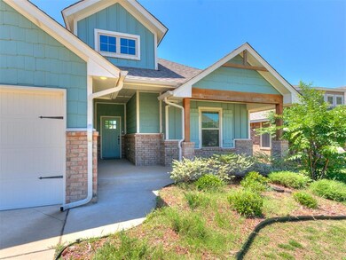 Craftsman-style home with a garage and covered por