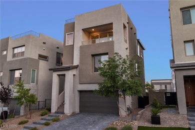 Modern home featuring an attached garage, stucco siding, and decorative driveway