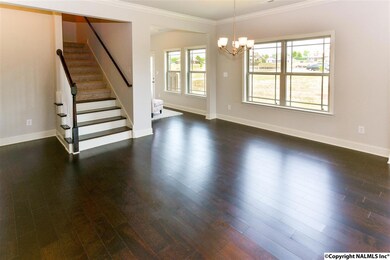 Hardwood flooring throughout this open plan