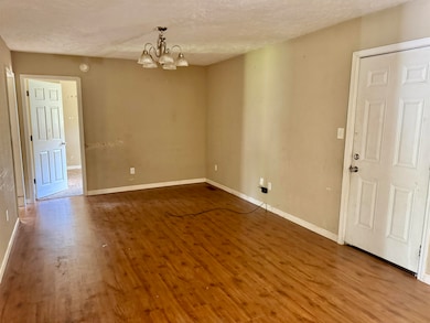 Unfurnished room with baseboards, an inviting chan